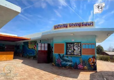 a building with a fish painting on the side at Mangrove Bay Resort in Quseir