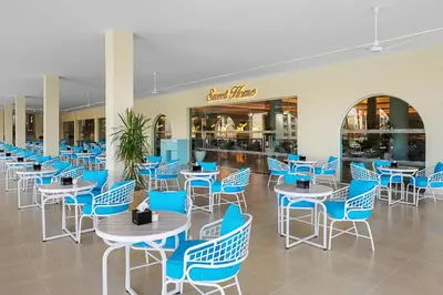 a cafeteria with blue chairs and tables in a mall at Pickalbatros Dana Beach Resort - Aqua Park in Hurghada