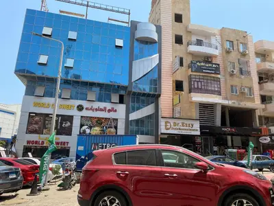 a red car parked in front of a building at Tamburine Chalet with Wi Fi Hurghada center in Hurghada