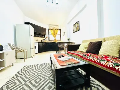 a living room with a couch and a table at Tamburine Chalet with Wi Fi Hurghada center in Hurghada