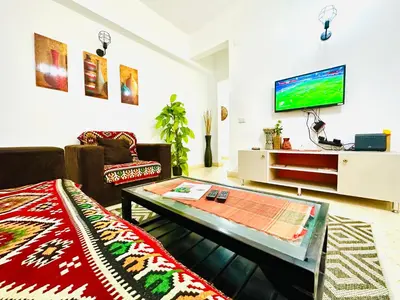 a living room with a couch and a coffee table at Tamburine Chalet with Wi Fi Hurghada center in Hurghada
