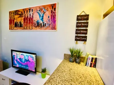 a room with a desk with a computer on it at Panda Grey with balcony Hurghada center in Hurghada