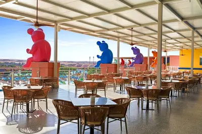 a restaurant with tables and chairs with teddy bears at Pickalbatros Jungle Aqua Park - Neverland Hurghada in Hurghada