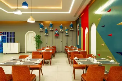 a restaurant with tables and chairs in a room at Pickalbatros Jungle Aqua Park - Neverland Hurghada in Hurghada