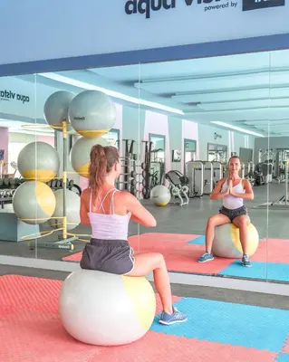 two women sitting on an exercise ball in a gym at Pickalbatros Aqua Blu Resort - Hurghada in Hurghada
