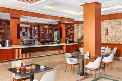 a restaurant with tables and chairs and a bar at Pickalbatros Aqua Park Resort - Hurghada in Hurghada