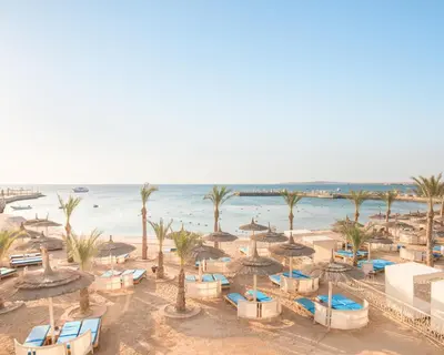 an aerial view of a beach with umbrellas and the ocean at Pickalbatros Aqua Vista Resort - Hurghada in Hurghada