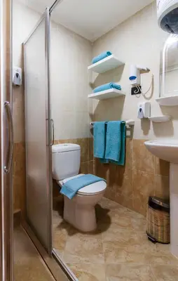 a bathroom with a toilet and a shower and a sink at Redcon Suites in Hurghada