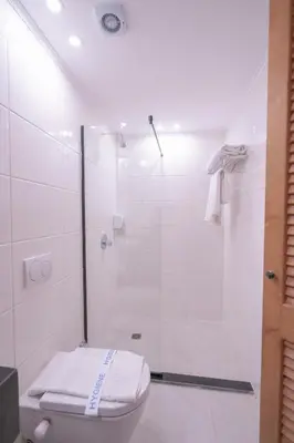 a bathroom with a toilet and a shower at Redcon Suites in Hurghada