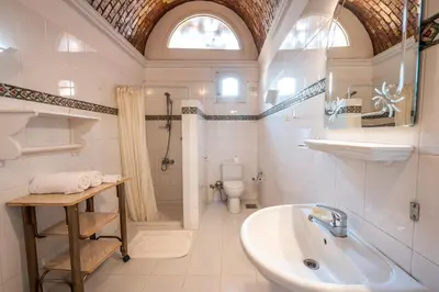 a bathroom with a sink and a tub and a toilet at villa al diwan luxor in Luxor