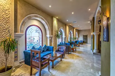 a waiting room with blue couches and chairs at Sunrise Mamlouk Palace Resort in Hurghada
