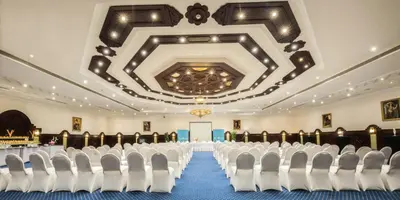 a conference room with white chairs and a ceiling at Sunrise Garden Beach Resort in Hurghada