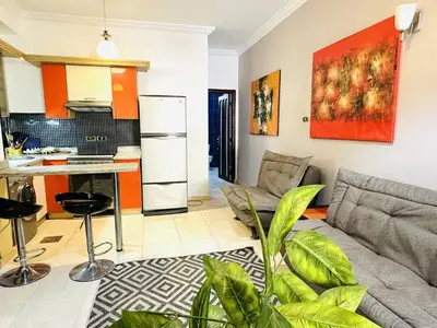 a living room with a couch and a kitchen at Diamond Arabia with Wi Fi in Hurghada