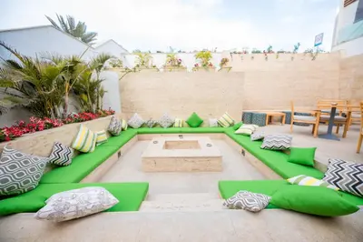 a patio with a green couch and pillows at Sunrise Holidays Resort -Adults Only in Hurghada