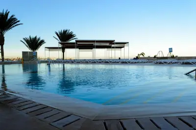 a swimming pool with a gazebo and palm trees at Sunrise Holidays Resort -Adults Only in Hurghada