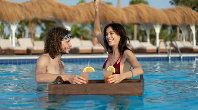 a man and a woman in a swimming pool at Meraki Resort - Adults Only in Hurghada