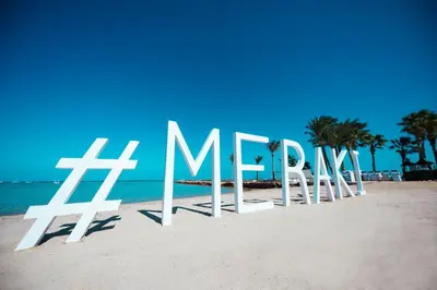 a sign on a beach with the word mexico at Meraki Resort - Adults Only in Hurghada