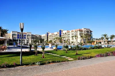a resort with a park with palm trees and buildings at Premier Le Reve Hotel & Spa Sahl Hasheesh - Adults Only 16 Years Plus in Hurghada
