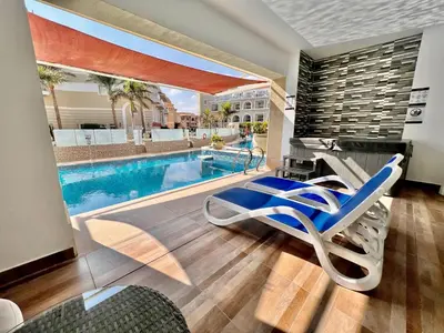 a room with a swimming pool and a lounge chair at KaiSol Romance Resort Sahl Hasheesh - Adults Only in Hurghada
