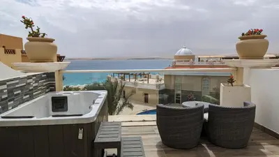 a balcony with chairs and a view of the ocean at KaiSol Romance Resort Sahl Hasheesh - Adults Only in Hurghada