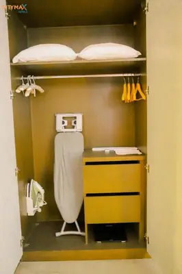 a closet with a sink and a desk and a bed at Aswan Plaza Hotel in Aswan