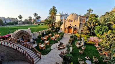 an aerial view of a building with a bridge and a yard at Embrace Hotel in Luxor