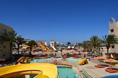 a large pool with a slide and a water park at Comfortable studio in hotel Karma with private beach and pools family only or female in Hurghada