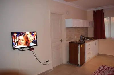 a television hanging on a wall in a kitchen at Comfortable studio in hotel Karma with private beach and pools family only or female in Hurghada