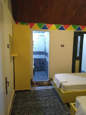 a room with a door with a colorful ceiling at Meshra Katto in Aswan