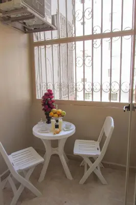 a white table and two chairs and a window at Apartments Desert rose near the sea RedSeaLine in Hurghada