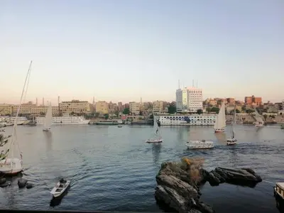 a group of boats in a body of water with a city at El-amin Guest House in Aswan