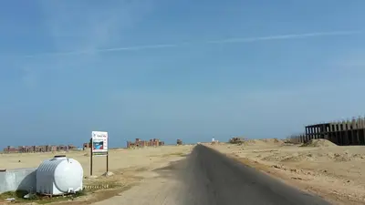 an empty road in the middle of a desert at Tiba Resort AA in Hurghada