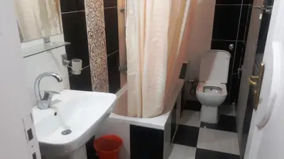 a small bathroom with a sink and a toilet at Adam and Eve House in Luxor