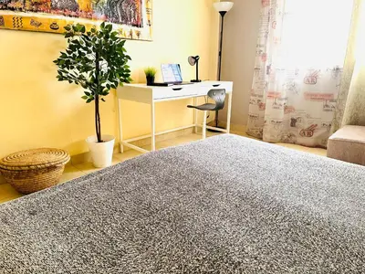 a room with a desk and a table with a plant at Safari Home with Wi Fi Hurghada center in Hurghada