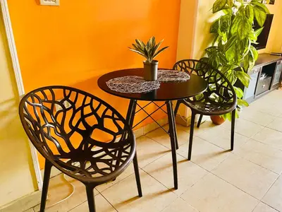 a table with two chairs and a table with a plant on it at Safari Home with Wi Fi Hurghada center in Hurghada