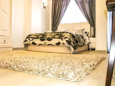 a bedroom with a bed and a rug at Lima Modern Sheraton with Wi Fi in Hurghada