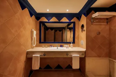 a bathroom with a sink and a mirror at Grand Makadi - Couples and Families Only in Hurghada