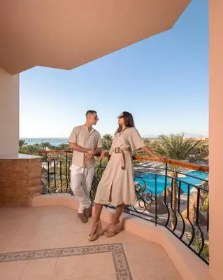 a man and a woman standing on a balcony at Siva Grand Beach in Hurghada