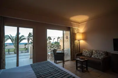 a bedroom with a bed and a view of the ocean at Hurghada Coral Beach Hotel in Hurghada