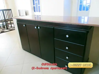 a black cabinet with a counter top in a room at Sunny Luxor in Luxor