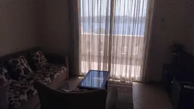 a living room with a couch and a glass table at Sunny Luxor in Luxor
