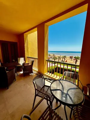 a balcony with a table and chairs and a view of the beach at New Marina MP 37 in Hurghada