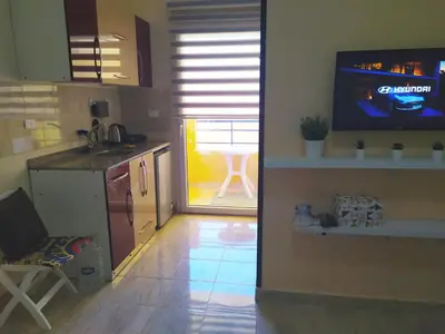 a kitchen with a television and a kitchen with a table at Budget studio near El Gouna and Kite station in Hurghada