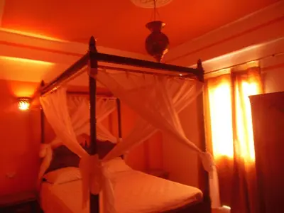 a bedroom with a canopy bed and a window at Cleopatra Hotel Luxor in Luxor