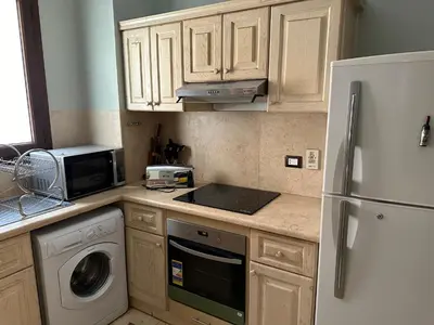 a kitchen with a white refrigerator and a microwave at El Gouna 2 bedrooms apartment South Marina Ground Floor in Hurghada