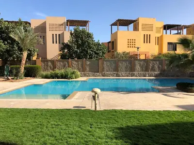 a swimming pool in a yard with buildings in the background at El Gouna 2 bedrooms apartment South Marina Ground Floor in Hurghada