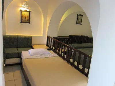 a room with two beds and a stair case at Arabella Azur Resort in Hurghada