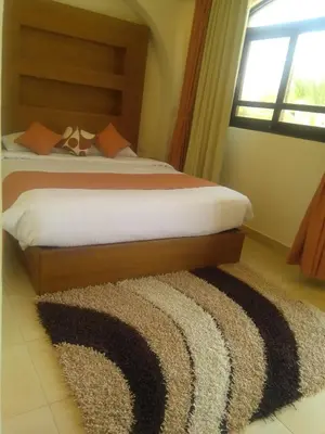 a bedroom with a bed and a rug at Arabella Azur Resort in Hurghada
