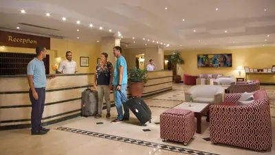 a group of people standing in a hotel lobby with luggage at Bel Air Azur Resort (Adults Only) in Hurghada