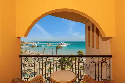 a balcony with a table and a view of the beach at Giftun Azur Resort in Hurghada